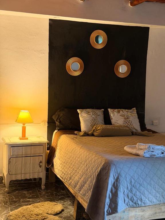 a bedroom with a large bed with a black headboard at Mis Montañas in Tinogasta