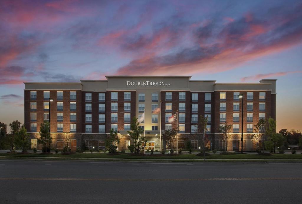 a rendering of a building with a sign on it at DoubleTree by Hilton Raleigh-Cary in Cary