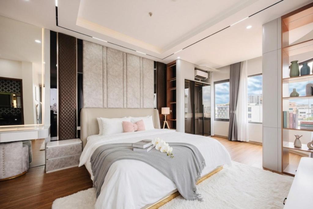 a bedroom with a large bed and a large window at Santori studio Hanoi in Hanoi