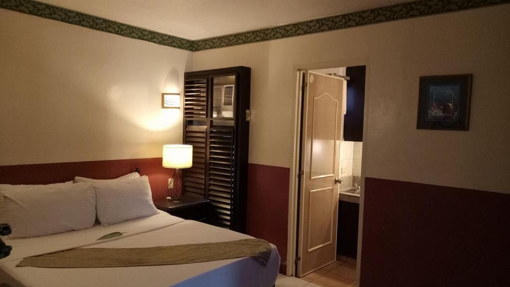 Postel nebo postele na pokoji v ubytování DM Residente Hotel Inns & Villas