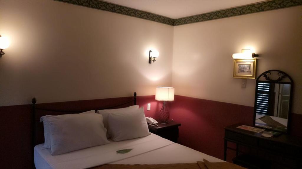Postel nebo postele na pokoji v ubytování DM Residente Hotel Inns & Villas