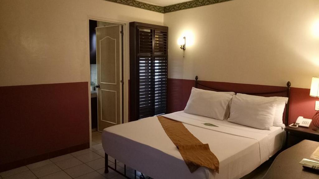Postel nebo postele na pokoji v ubytování DM Residente Hotel Inns & Villas