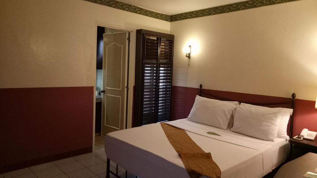 Postel nebo postele na pokoji v ubytování DM Residente Hotel Inns & Villas