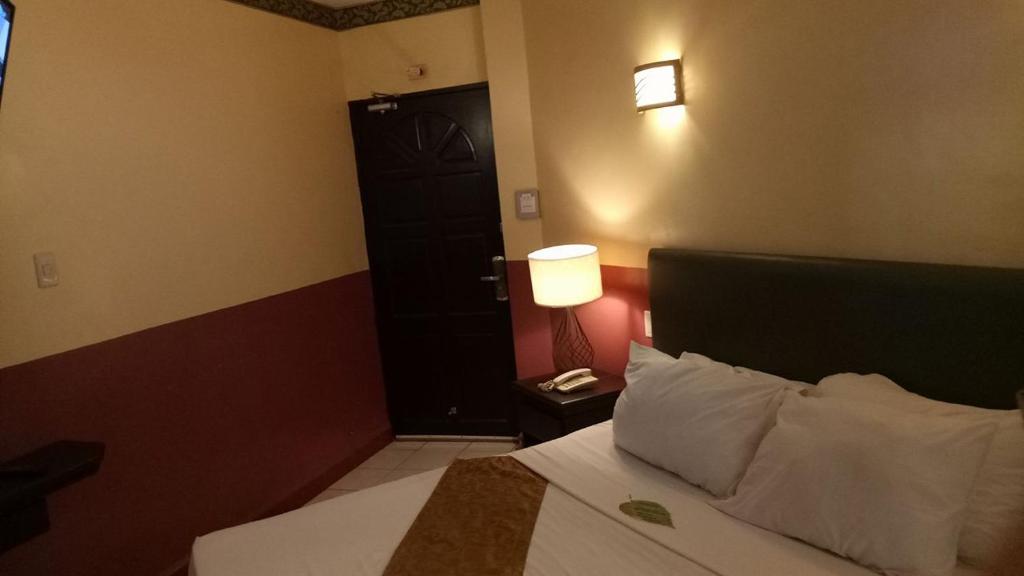 Postel nebo postele na pokoji v ubytování DM Residente Hotel Inns & Villas