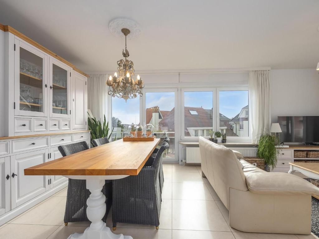 a kitchen with a table and chairs and a dining room at Rising Sun - 0101 in Westende-Bad