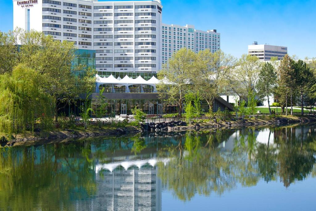 a river in a city with buildings in the background at DoubleTree by Hilton Spokane City Center in Spokane