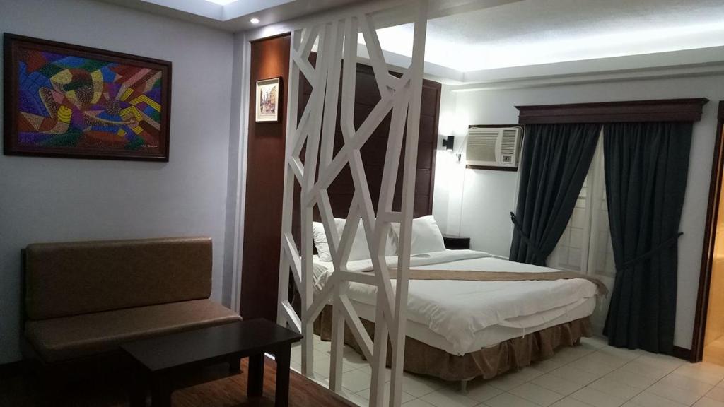 Postel nebo postele na pokoji v ubytování DM Residente Hotel Inns & Villas