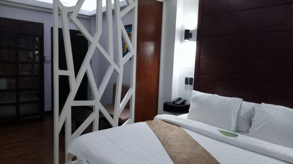 Postel nebo postele na pokoji v ubytování DM Residente Hotel Inns & Villas