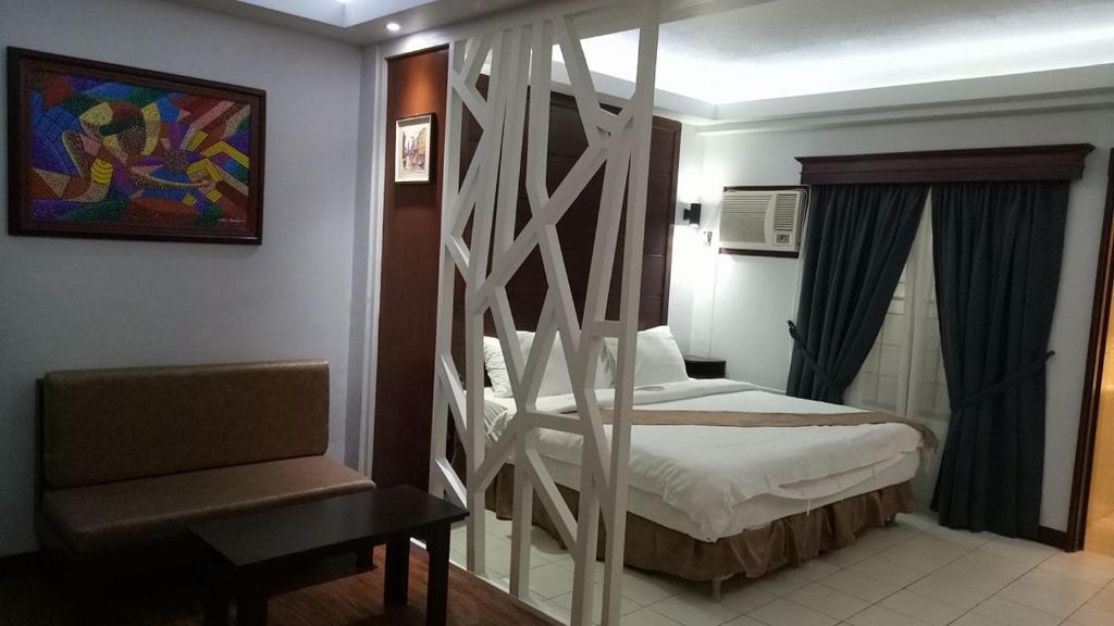 Postel nebo postele na pokoji v ubytování DM Residente Hotel Inns & Villas