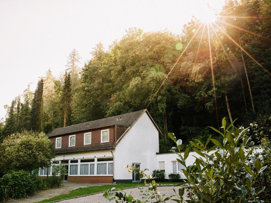 a house on a hill with the sun shining at Friedensthal in Bad Pyrmont