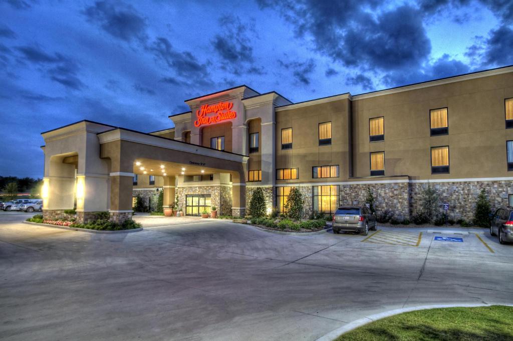 a hotel with a parking lot in front of it at Hampton Inn and Suites Ada in Ada