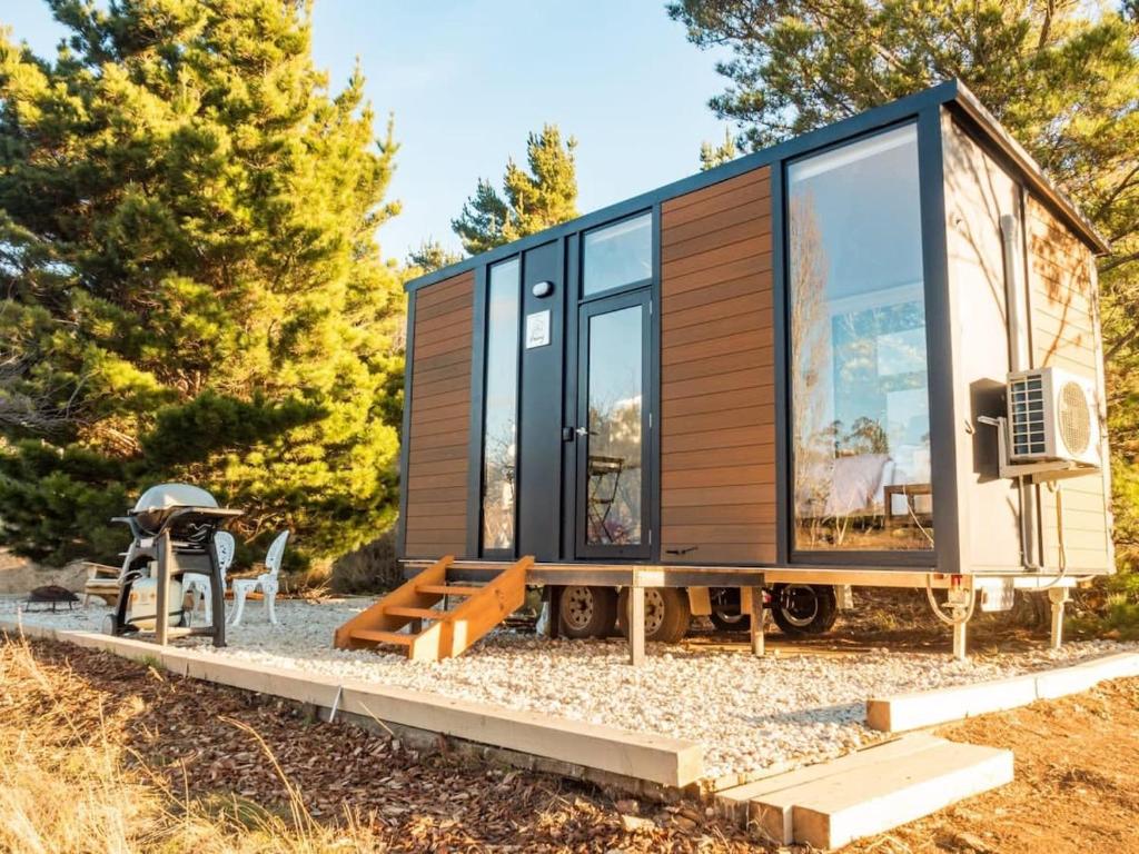 a tiny house on wheels on a trailer with trees at Blue Gum at Langdale 1 by Tiny Away in Bungendore