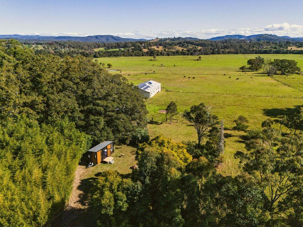 an overhead view of a house in a field at Huntingdon House by Tiny Away in Wauchope