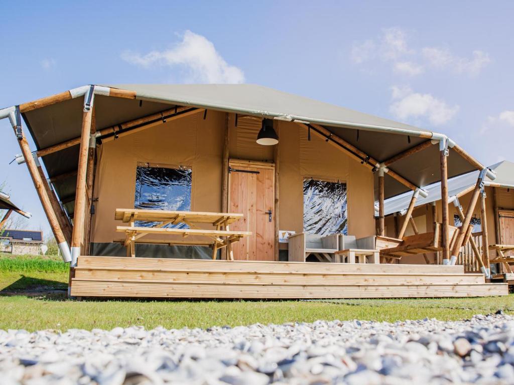 a cabin with a pitched roof on the grass at Glamping Lodge in Westerland