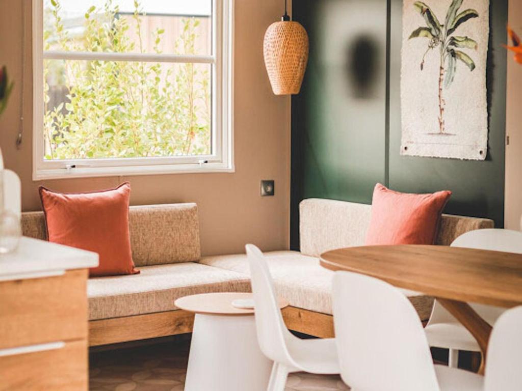 a living room with a couch and a table at Wadden Lodge Plus in Westerland