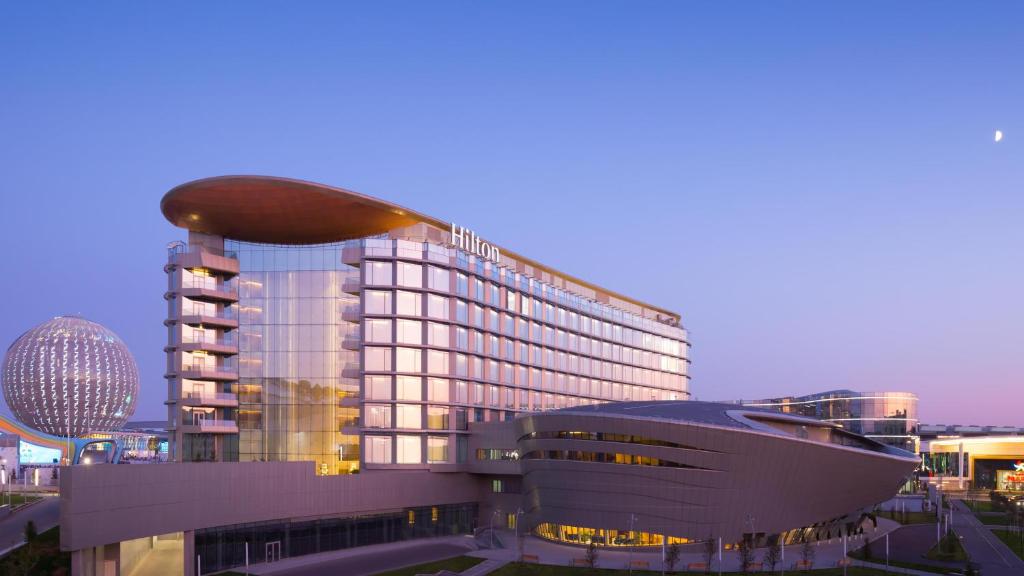 a large building with a bean on top of it at Hilton Astana in Astana