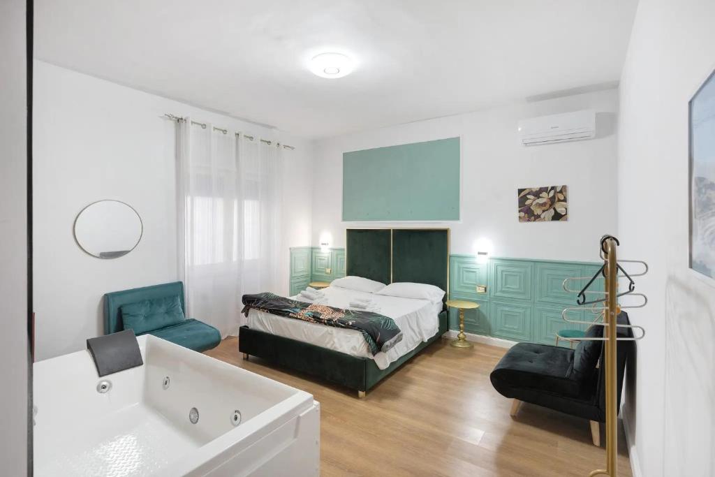 a bedroom with a bed and a bath tub in it at Mirosa Luxury Rooms in Pompei