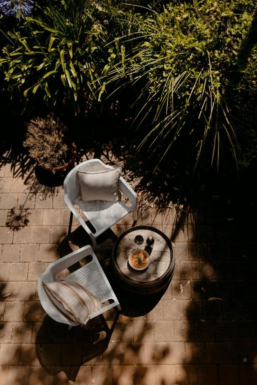 an overhead view of two chairs and a table with a plate of food at Norfolk House in Dunsborough