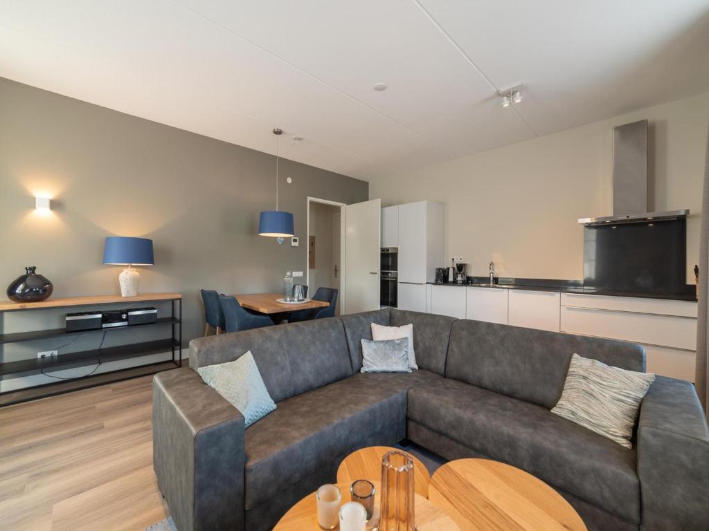 a living room with a couch and a table at La Mer Luxe in Colijnsplaat