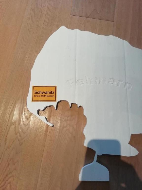a piece of a puzzle with a sign on it at Panoramablick-Orther-Hafen-Fehmarn in Orth