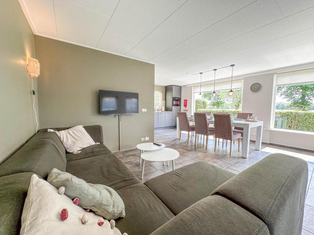 a living room with a couch and a table at Alpacafarm Vorstenbosch in Vorstenbosch