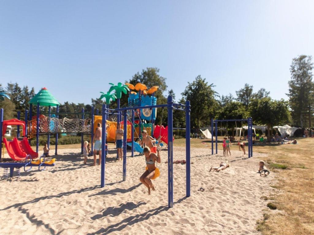 a group of people playing on a playground at Woodchalet in Vessem