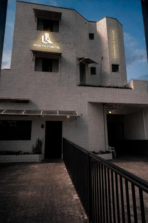 a building with a sign on the side of it at Hotel e Pousada Porto Forte in São Paulo