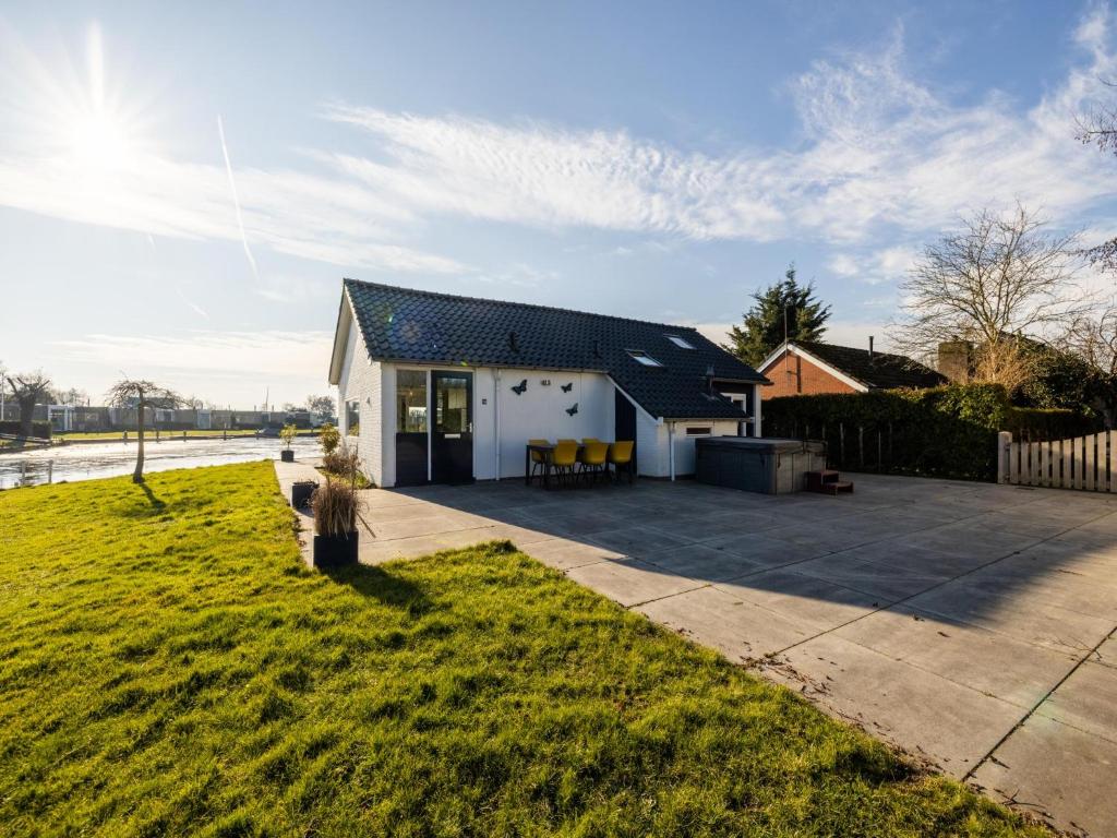 a white house with a black roof at Kieft in Boornzwaag