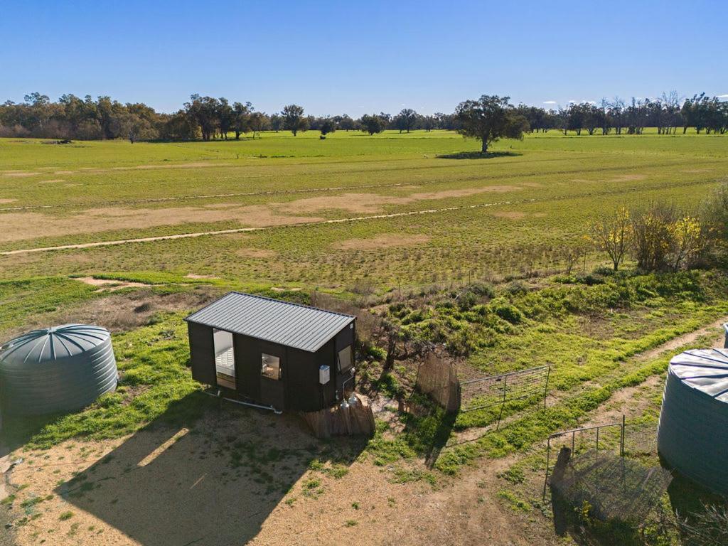 an aerial view of a tiny house in a field at Starry Night Farmstay by Tiny Away in Forbes