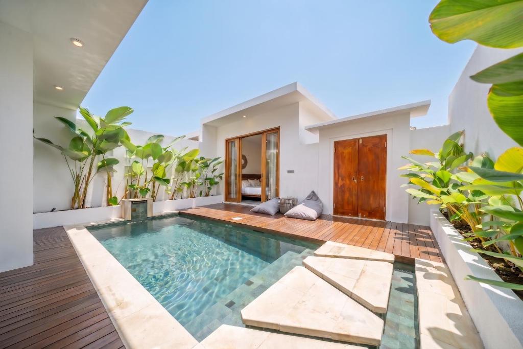 a swimming pool in the middle of a house at Sunset Heaven - Private Pool Cozy Villa with Patio in Kerobokan