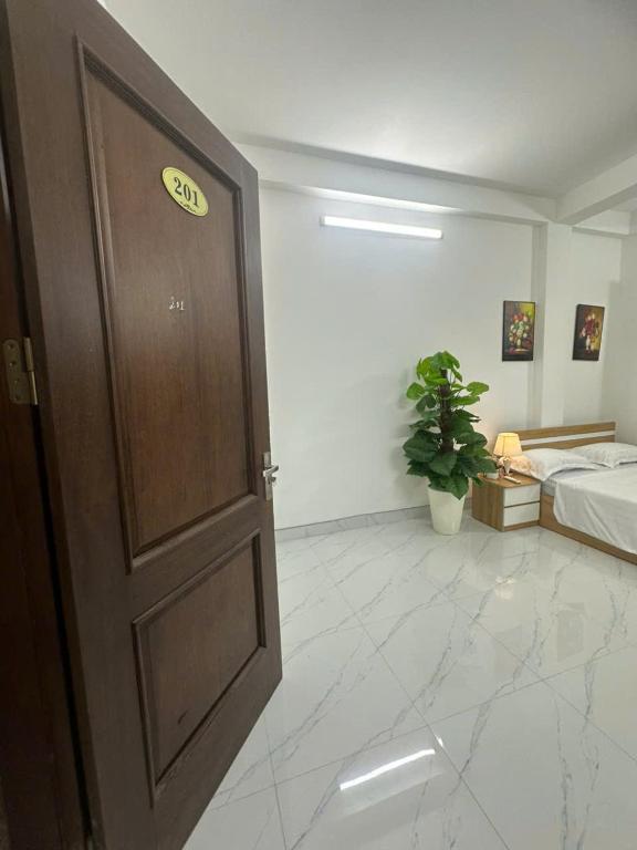 a door in a room with a bed and a bedroom at Harmony Apartment in Hanoi