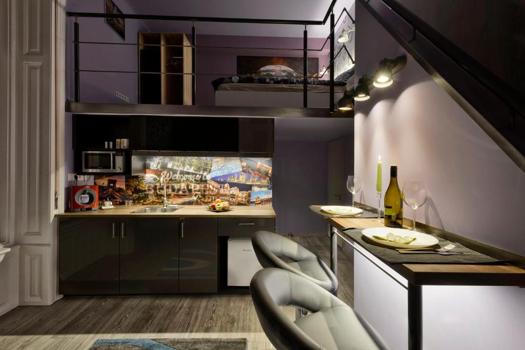 a kitchen with purple walls and a table and chairs at Rakoczi Studios in Budapest