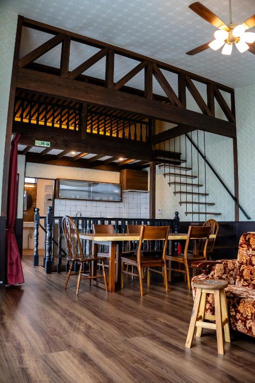 a dining room with a table and chairs at Taisho Roman-style Private Villa with Original Japanese Art 日本画原画の一棟貸し M's Lumos in Marugame