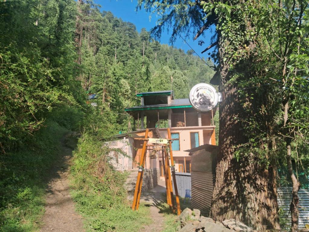 a building in the middle of a forest at Bhindeshi Tara Stays Jibhi Mihar in Jibhi