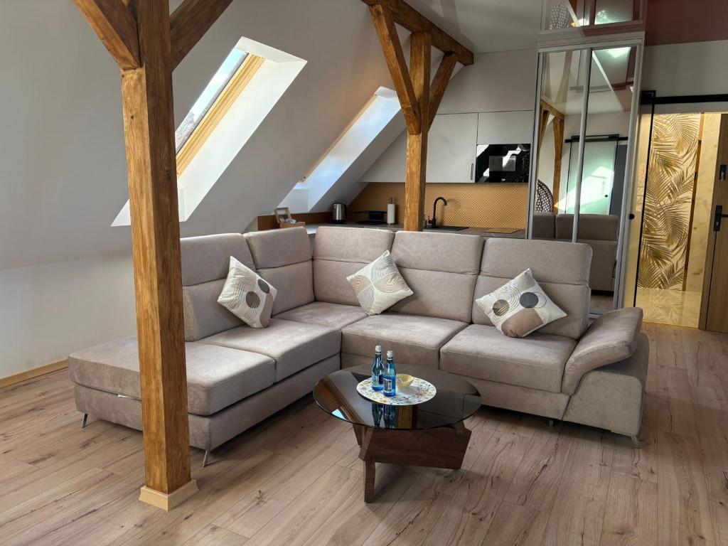 a living room with a couch and a table at Apartament Wypoczynkowy Centrum in Tuchola