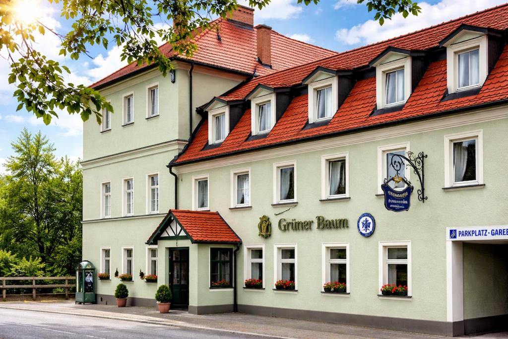 a large white building with a red roof at Grüner Baum in Bad Staffelstein