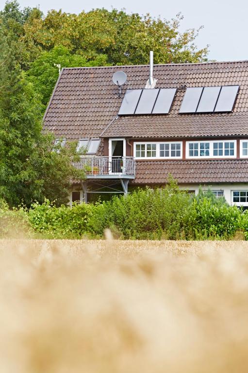a house with solar panels on the roof at Alte seester Schule in Westerkappeln