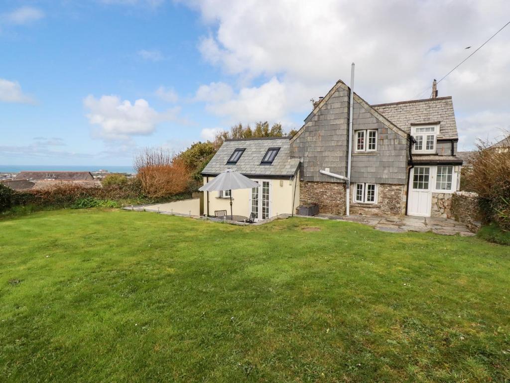 an image of a house with a large yard at Ivy Cottage in Tintagel