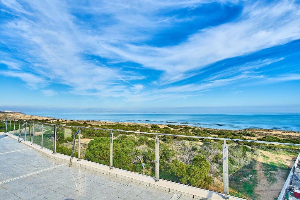 a view of the ocean from the balcony of a building at Espanhouse Pinada Beach in La Marquesa