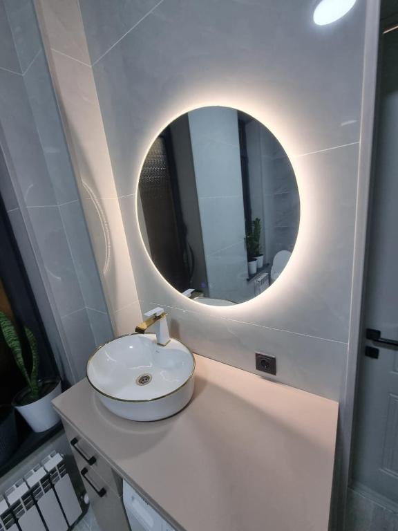 a bathroom with a sink and a mirror at Самал 3 in Shymkent