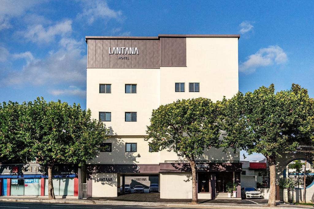 a tall white building with a sign on it at Lantana Daegu Shinam Branch in Daegu