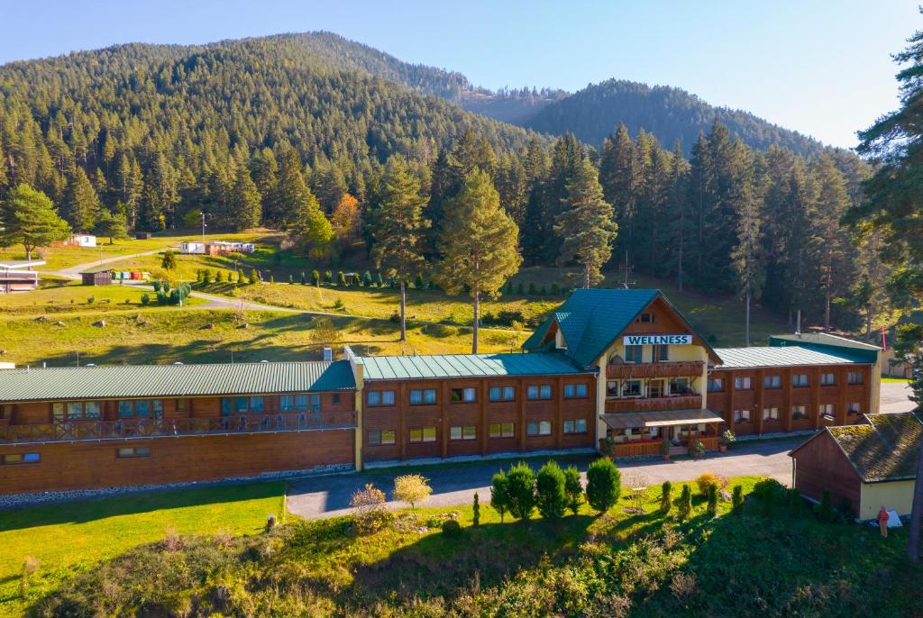 an aerial view of a building with a mountain in the background at Hotel Bystrina in Belá