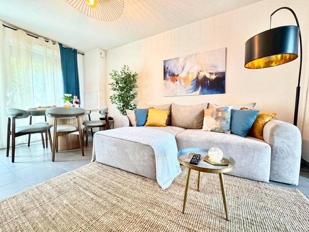a living room with a couch and a table at Charming Tournefeuille House in Tournefeuille