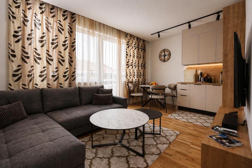 a living room with a couch and a table at Urban Getaway Sarajevo with Free Parking in Sarajevo