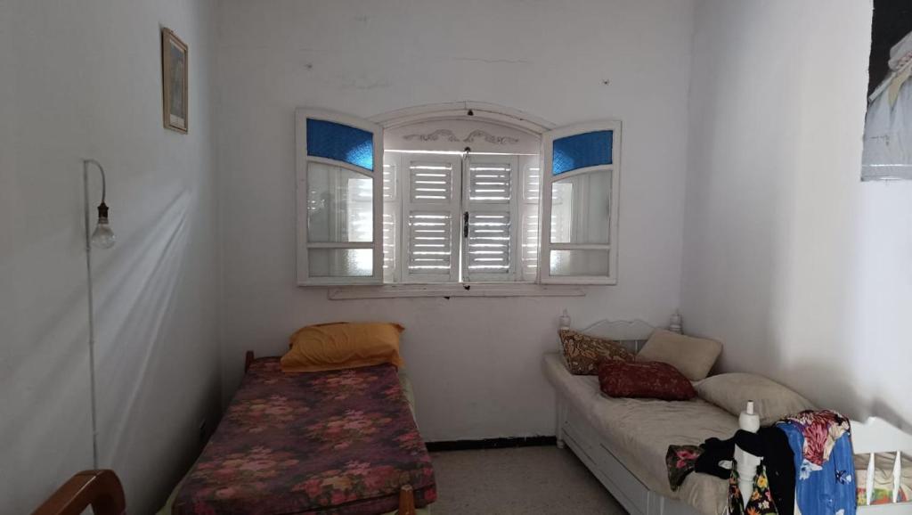 a living room with a couch and a window at Charmante maison plage in Soliman