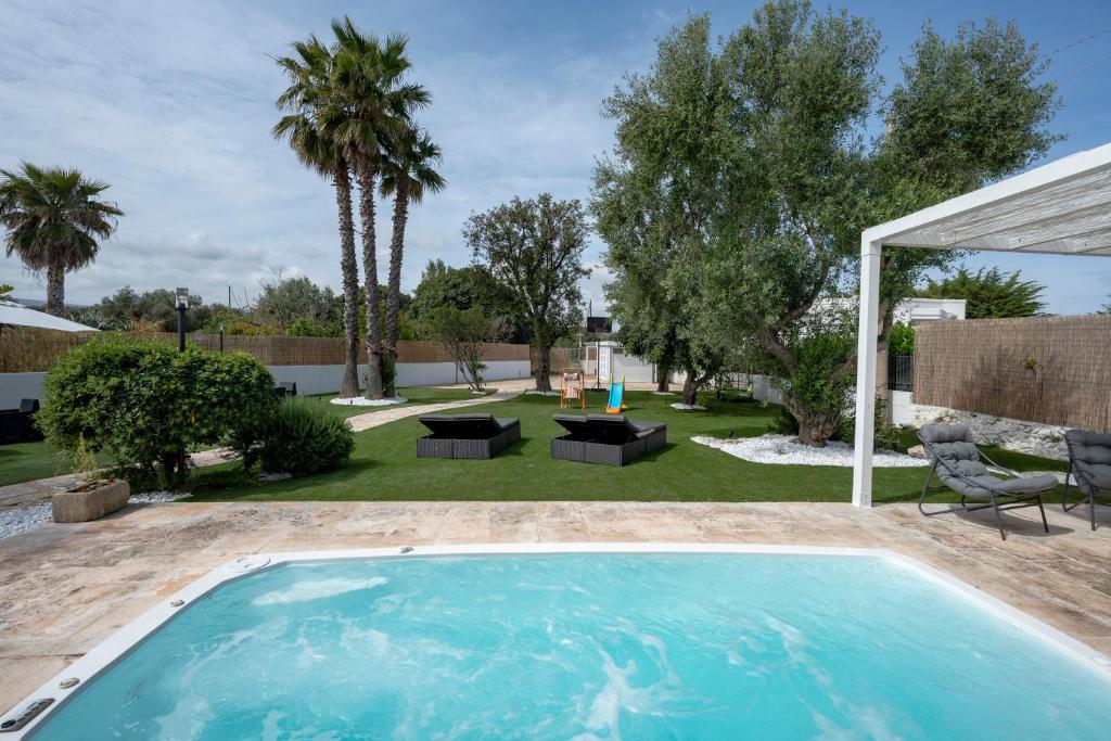 a swimming pool in the backyard of a house at GuestHost - Lume di Mare in Faccia di Trippa
