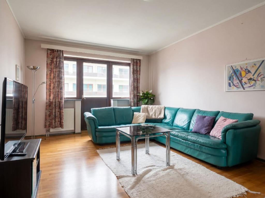 a living room with a green couch and a table at JS10 - 2BR Central Bergen Views in Bergen