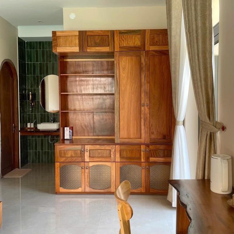 a bathroom with a wooden cabinet and a sink at Gió nồm in Phú Hiệp