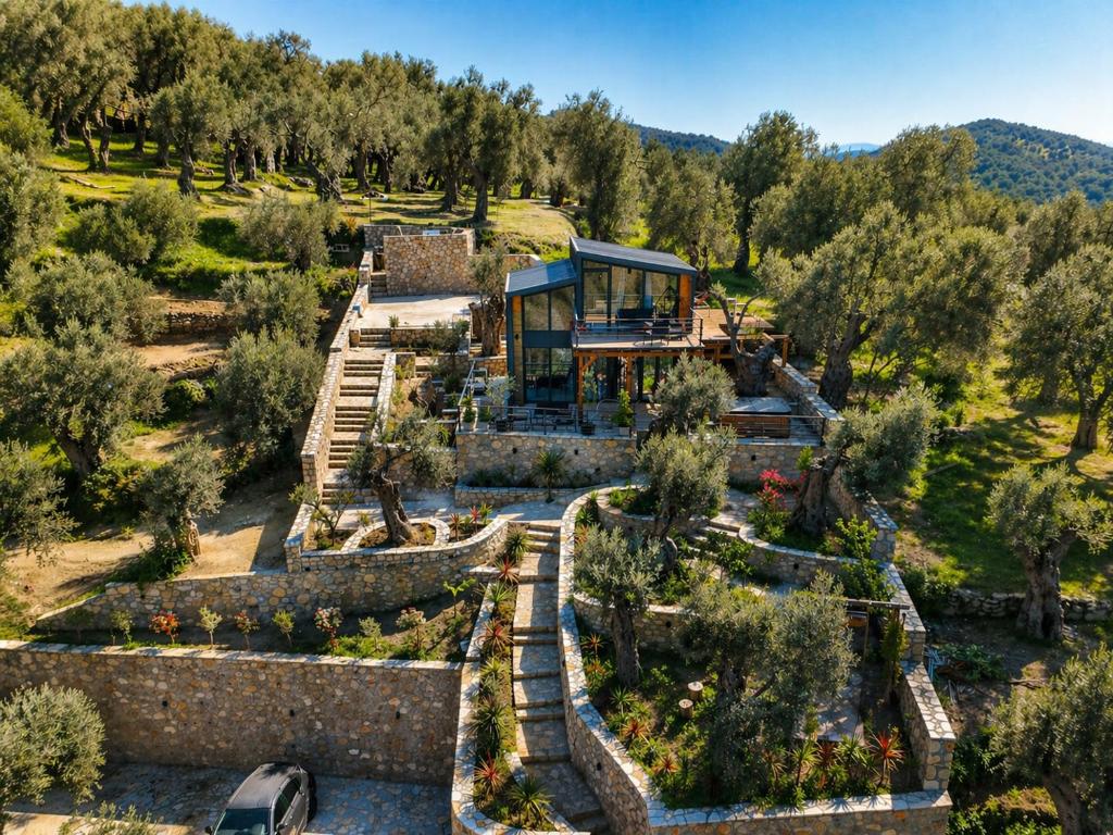 a house on top of a hill with trees at Villa Tramonto D'Oro in Ulcinj