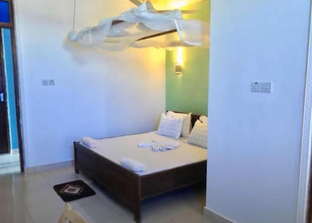a bed in a room with a ceiling at 27Azmaa hotel & safaris in Zanzibar City